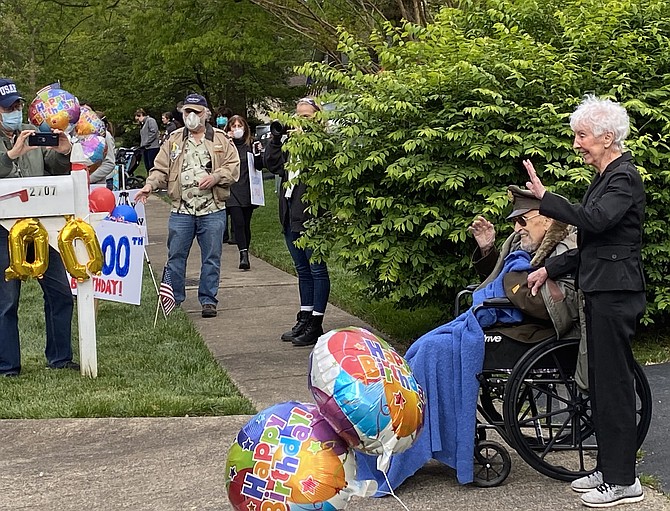 With wife Julia by his side, Herndon resident Air Force Col. Robert A. Shawn (Retired) who turned 100 years old, smiles as more than 120 vehicles join the birthday caravan parade organized by his fellow Post members at Veterans of Foreign Wars Loudoun County Post #1177.
