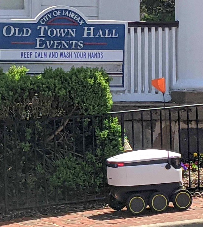 A Starship robot chugs up University Drive on a food-delivery mission.