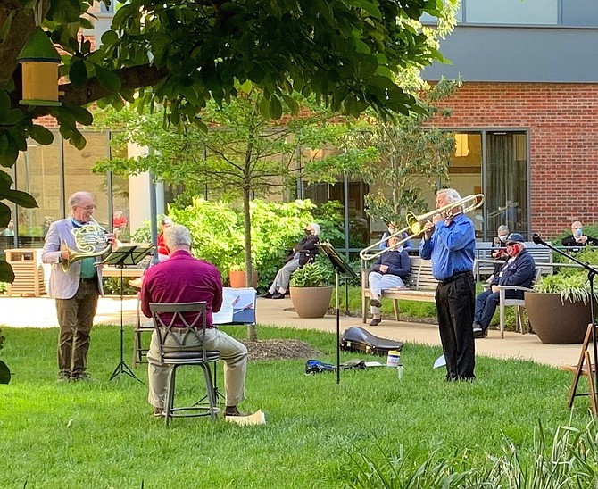 Led by music director James Ross on French Horn, a brass trio from the Alexandria Symphony Orchestra serenades residents at Goodwin House Alexandria during a 30-minute concert on May 7.