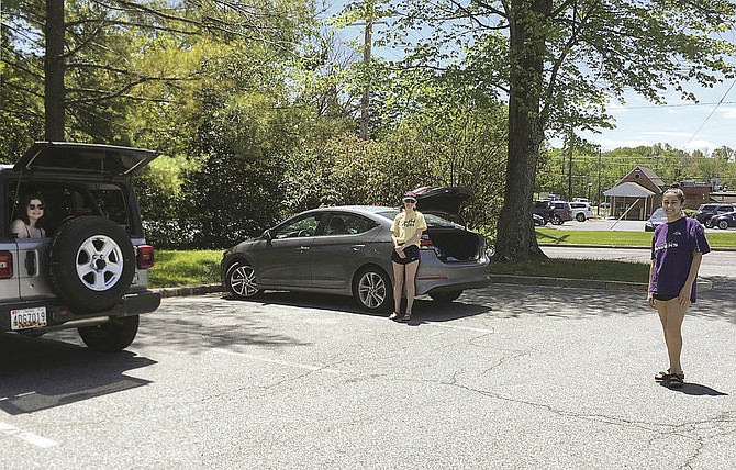 Sophie Shapiro, in the back of her car, Maya Rosenberg, standing next to hers, and Sheerin Naimi, right, enjoy a “social distancing” visit in the Potomac Library parking lot Saturday.