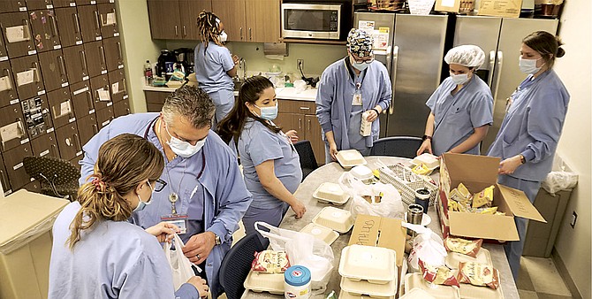 Arlington Virginia Hospital Center (VHC) workers choose a free donated lunch on Thursday during National Nurses Week. It was provided by a partnership between Amazon and Freddie’s Beach Bar and Restaurant on 23rd Street.