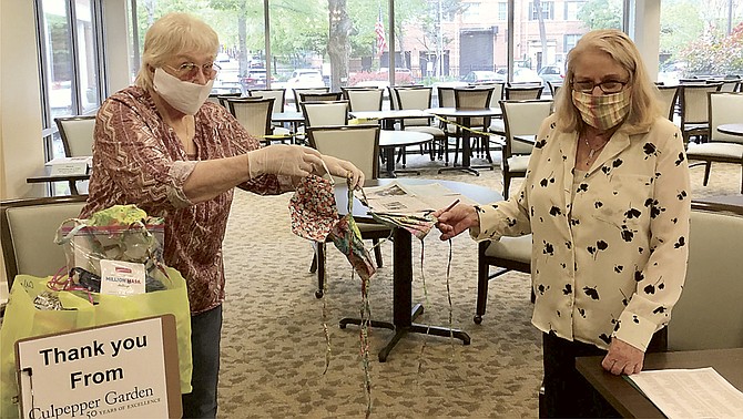 Edie Mims distributing fabric masks at Culpepper Garden.