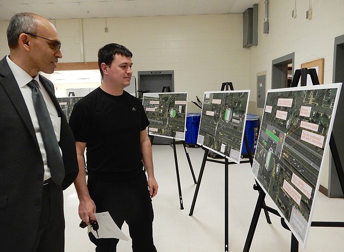 Chantilly resident James Brooks (on right) asks lead project consultant Ravi Raut about bus shelters and a proposed new traffic signal at Route 50 and Galesbury Lane.