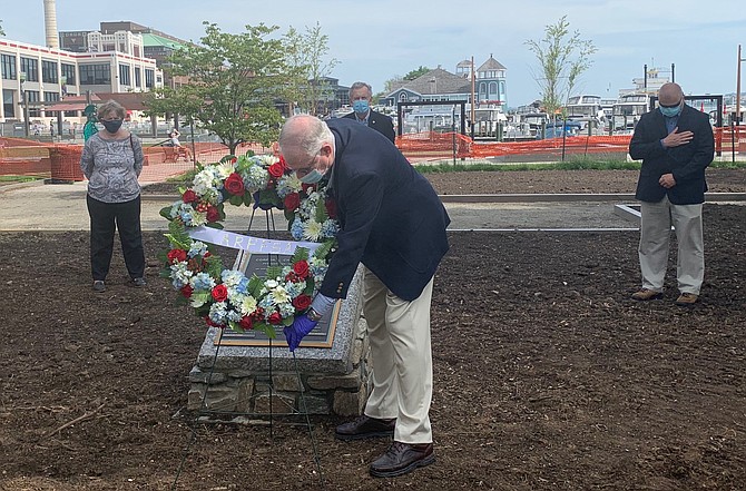 Retired police Captain Ken Howard places a wreath at the Fallen Officers Memorial May 15 at Waterfront Park.