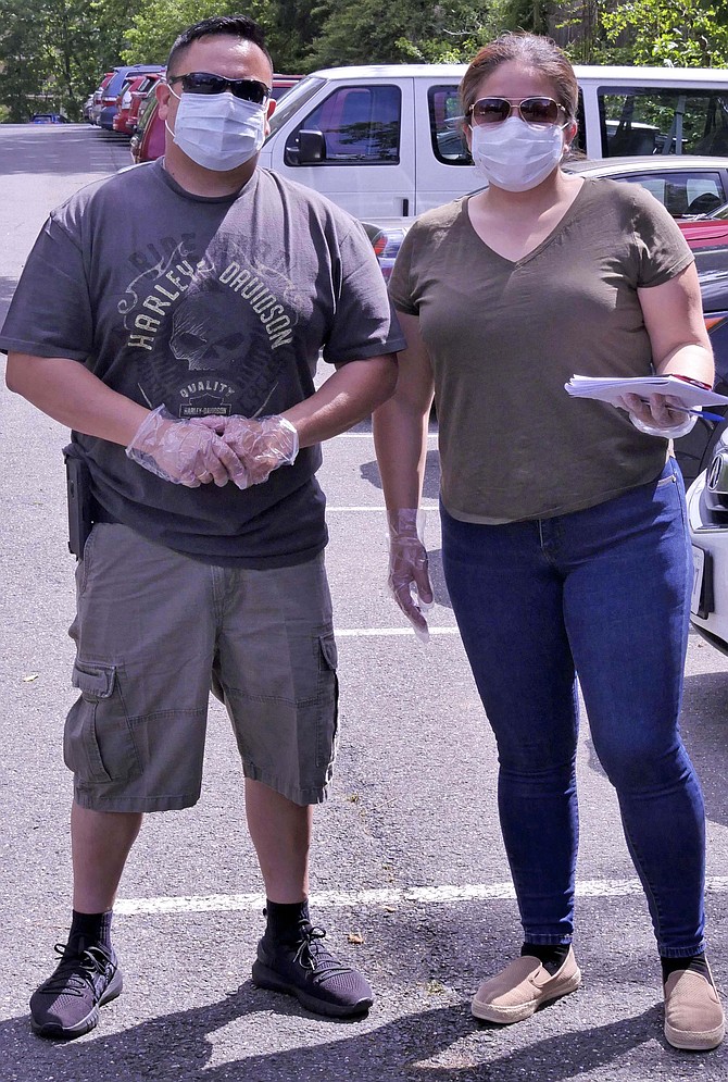 Claudia Cuellar and her husband Hector Ramirez, with children at Campbell Middle School and Washington-Liberty High School, have been delivering free groceries since the parents’ group began in March.