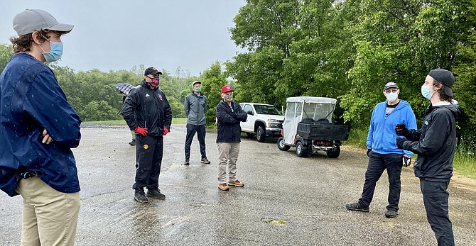 Disc golf team leader, Kemper Pogue (right) Woodbridge, shares work plan with volunteers (from left) Andrew Pardo, Chantilly; Nick Gonzalez, Springfield; Trey Tucker, Chantilly; Buddy Rogers, Lorton; and Kevin Carr, Burke, on basket set up plan.