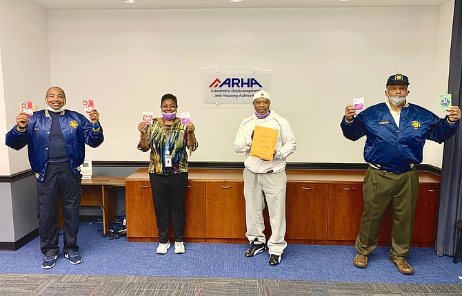 ARHA CEO Keith Pettigrew, second from right, poses for a photo with Departmental Progressive Club president Merrick Malone, left, ARHA resident director Gaynelle Bowden-Diaz, and DPC’s William Chesley on May 21 following the presentation of $890 in grocery gift cards from the DPC to ARHA.