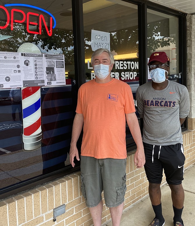 (From left) Chris Dittes and Richard Spencer of Reston wait in line for haircuts, masked and ready to abide with Executive Order 63 requiring all Virginians to wear face coverings while inside public spaces.