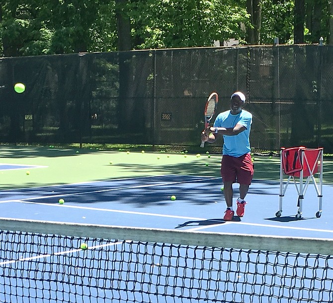 Keanu Owusu, from 4 Star Tennis, gives a private lesson at Potomac Swim and Tennis on Saturday, May 30.