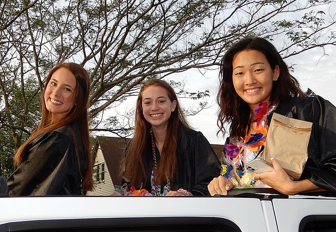 (From left) Kailee Corbett, Ellie Reimer and Taylor Kim smile from a sunroof.