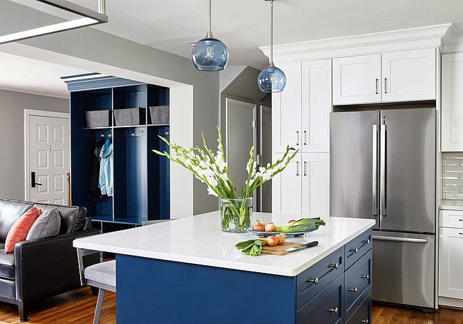 Blue pendant lighting hangs above a white quartz-topped island in this kitchen by interior designer Elena Eskandari, Case Design/Remodeling, Inc.