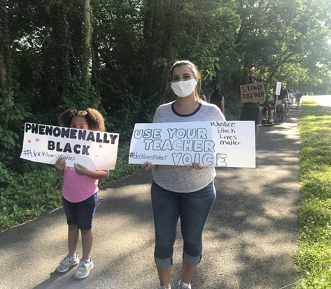 Catalina Burris, left, is “Phenomenally Black.” With Constance Greiggs, whose sign reads, “Use Your teacher voice, black lives matter.”