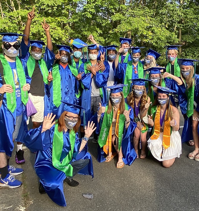 Friends back together, and now the newly minted SLHS graduates Class of 2020, masked, capped and gowned, gather on the evening of a drive-by parade in their honor organized by parents and the community.