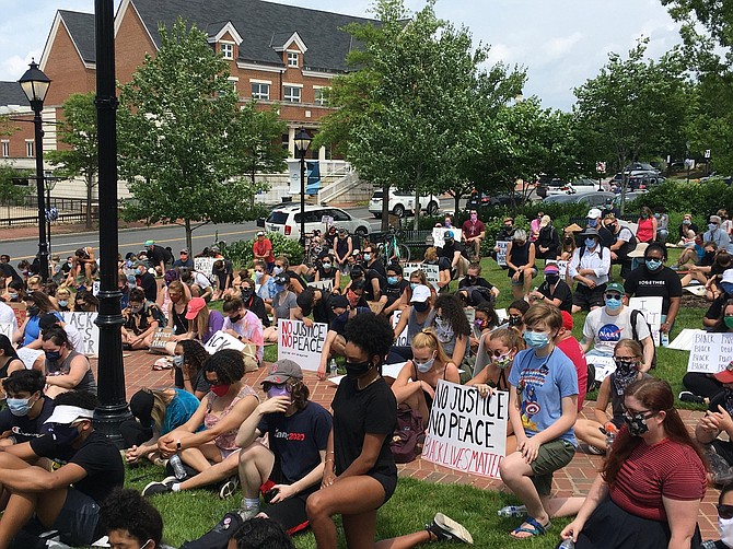 People at Fairfax City’s Black Lives Matter protest on Saturday observe 8 minutes, 46 seconds of silence in George Floyd’s honor.
