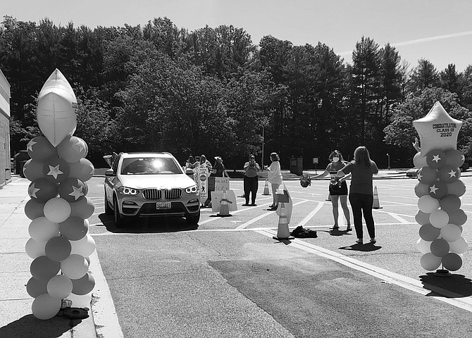 Wootton High School seniors were greeted with balloons and applause when they arrived at the school to pick up caps and gowns last week.