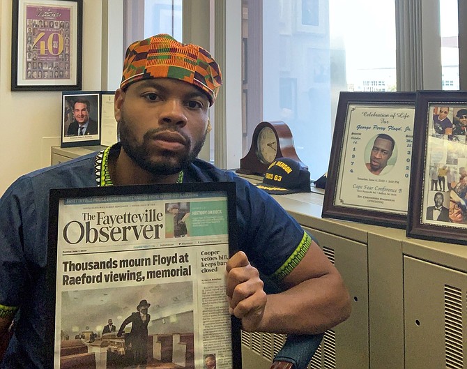 Local attorney Tavares Floyd holds a newspaper clipping detailing the private family memorial held June 6 for his cousin George Floyd. The May 25 death of George Floyd during an arrest in Minneapolis has sparked weeks of protests across the country.