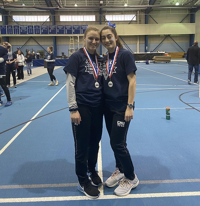 Lindsey Stirling (left) of Falls Church with Adrianna DeSantis (right) at Christopher Newport University’s indoor track at the Freeman Center, after their track team won their conference meet in February.