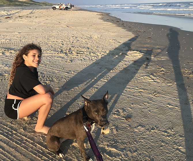 Allayna Eichner and Tigger at play in North Carolina’s Outer Banks. Newly adopted Tigger rounds out the family of Allayna and her mother, Cassandra Eichner, of Alexandria.