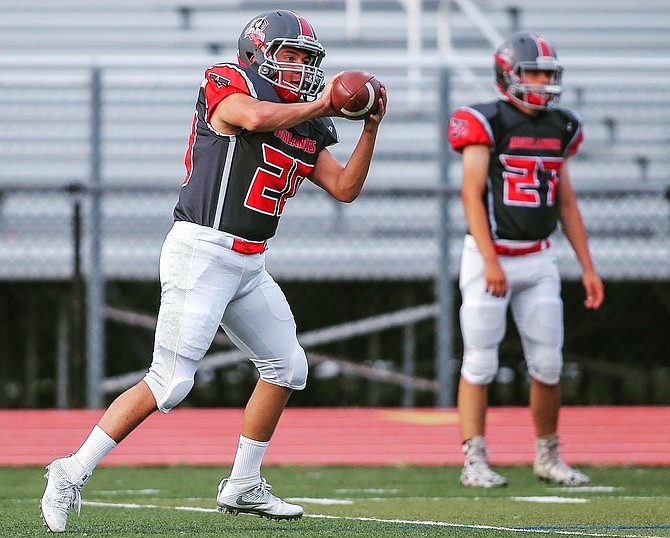 Prior to a game, Jaden Sarinana of McLean practices linebacker drills to get ready to play.