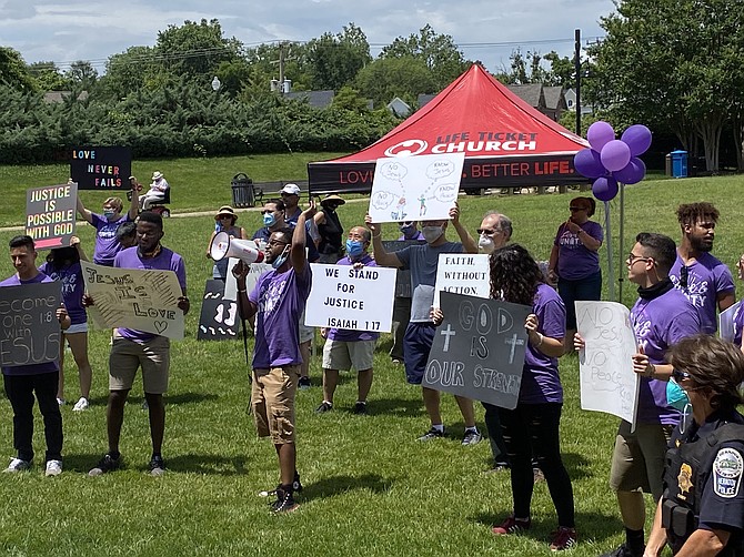 Marchers bear the heat of the summer sun, ready to release prayers while standing together with the Town's police and the community.