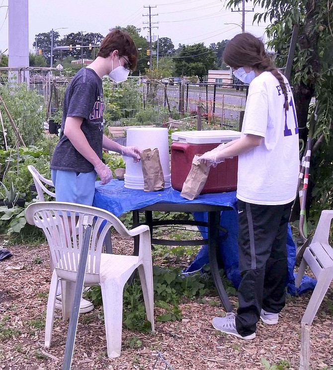 Ryan and Allie Mansinne volunteer with their mother Lori to deliver fresh produce on Mondays to St. Charles Borromeo Catholic Church for food distribution on Tuesdays. Allie says she has learned how to eyeball weights and how long it takes for vegetables to grow.