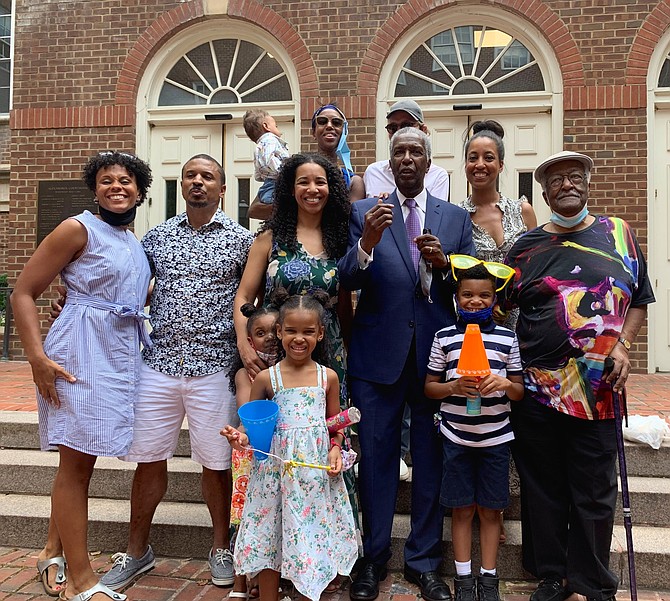 Circuit Court Judge Nolan Dawkins poses for a photo with family members on the steps of the Franklin P. Backus Courthouse during a surprise retirement celebration June 26 in Old Town.