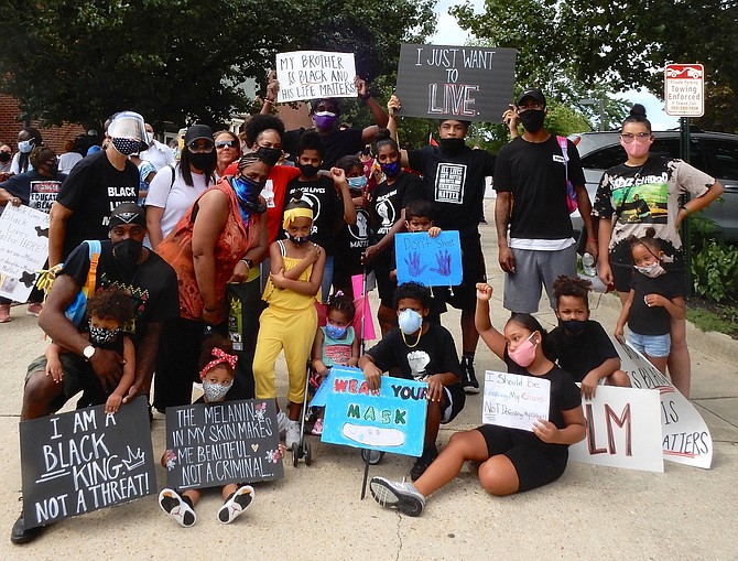 With signs and facemasks, this group prepares to march from Mount Calvary Baptist Church to Fairfax City Hall.