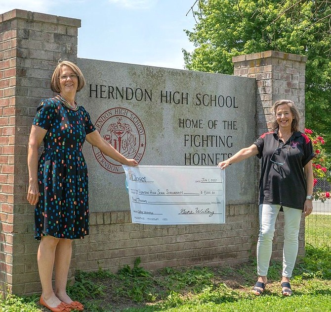 Rachel Williams, Scholarship Director for The Closet of the Greater Herndon Area, Inc, presents a check for $9,000 to a representative from Herndon High School, Deb Peirce, College & Career Center Specialist and College Partnership Program Advocate.