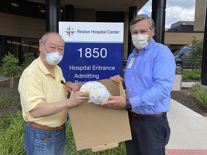 Great Falls resident David Chien delivers 100 N95 masks to Todd McGovern, Director of Marketing and Communications at Reston Hospital Center.