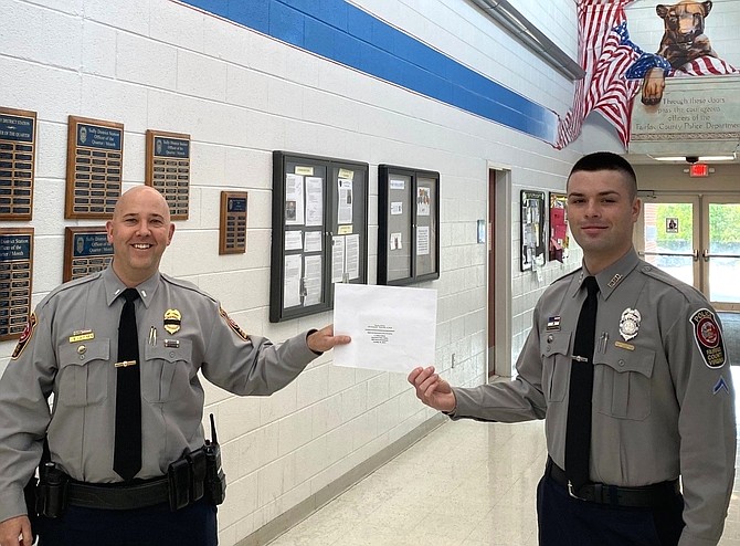 (From left) Lt. Josh Laitinen presents the certificate to PFC Thomas Rubinstein.