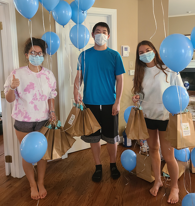 Teen volunteers Elisa Zoltick, Austen Chen and Stephanie Zoltick prepare to deliver balloons and goodie bags to members of Potomac Community Village. The group celebrated its 8th birthday with a virtual party June 23.