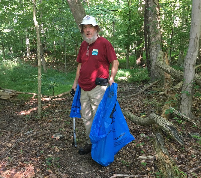Dan Ramsey pauses during a morning of trash collection along the C&O Canal Saturday. About 50 volunteers registered to help at the event sponsored by the C&O Canal Trust.
