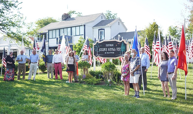 Sponsors of the Flags for Heroes program gather for a photo on the lawn of Cedar Knoll Restaurant for a July 9 reception.