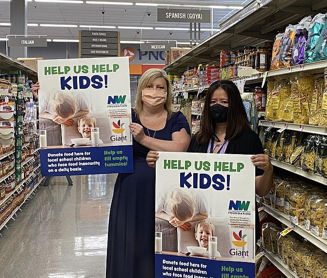 Mary Kaye "Kaycee" Childress, Executive Director of the Northwest Federal Credit Union Foundation, the philanthropic arm of Northwest Federal Credit Union, and Pham Ngocmy of the Giant Food store located at 2425 Centreville Road in Herndon.