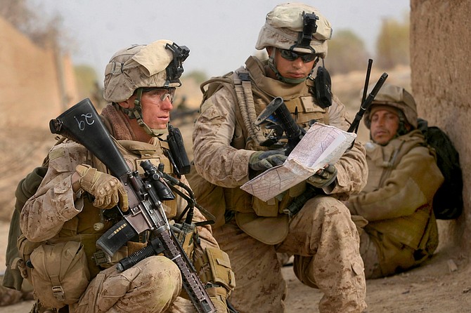 U.S. Marine Corps Staff Sgt. Ryan Clay, left, and Cpl. Anthony Deprimo study a map while on a patrol in Marjah in Helmand province, Afghanistan, Feb. 21, 2010. Clay and Deprimo were assigned to India Company, 3rd Battalion, 6th Marine Regiment.