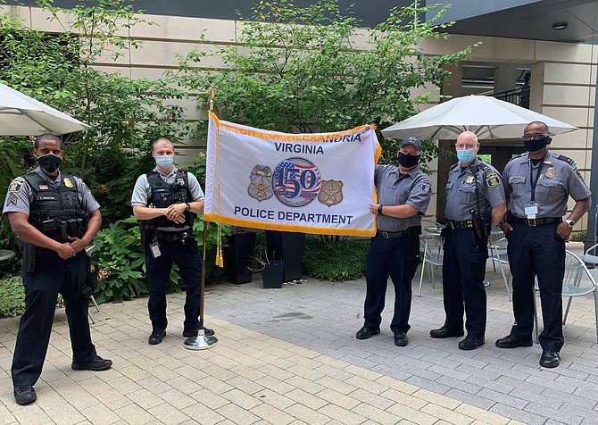 Members of the Alexandria Police Department hold a banner marking the 150th anniversary of the department’s founding July 15 at police headquarters. Shown are: Sgt. Biruk Dessalegn, Officer Kirill Schipanov, Motor Officer Loren Smithwest, Lt. Chris G. Ware and Lt. Bart Bailey.