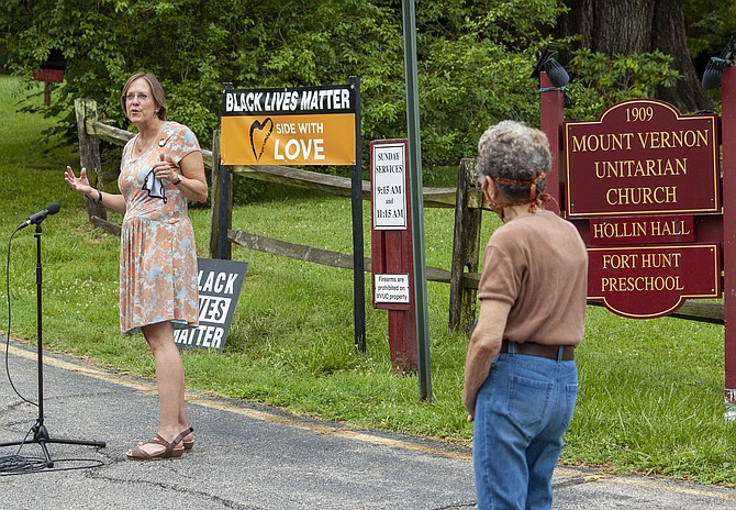 Rev. Kate Walker dedicates a “Black Lives Matter” sign at the entrance to the Mount Vernon Unitarian Church on Windmill Lane.