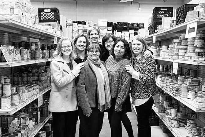 Harmonie Taddeo, Executive Director at Western Fairfax Christian Ministries (far right) and staff pause a moment in the organization's food pantry which serves clients at risk of hunger who reside in Oak Hill, Fairfax, Centreville, Clifton, Fairfax Station, Chantilly and Fair Oaks.  (File photo dated before COVID-19.)