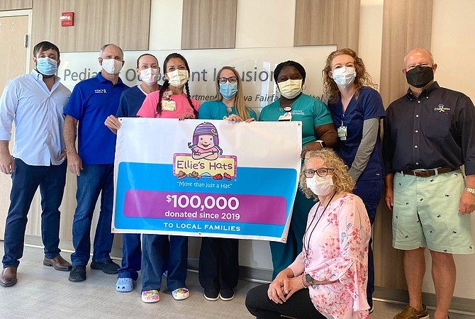 (Standing, from left) are Joe DePalma (of Ellie’s Hats’ Website), Jay Coakley, nurses from Pediatric Specialists of Virginia, Brian Drummond (Ellie’s Hats Board member), and (kneeling) is Cathy Bottrell (Life With Cancer social worker).