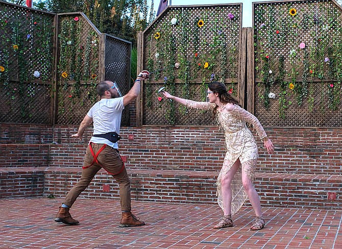 Fencing are Justin Winters (as Duke Theseus) and Isabelle Baucum (as Hippolyta).