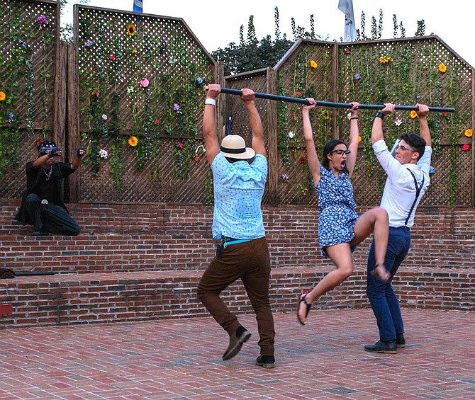 Lysander (Brandon Benitez, Woodbridge) and Demetrius (Benjamin Cudmore, Vienna) hold back Hermia (Graciela Perez, Centreville) from attacking Helena (Jordan Hundley, Chantilly) after Lysander declares his love for Helena.