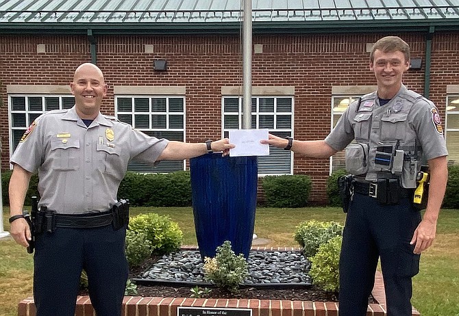(From left) Assistant Station Commander, Lt. Josh Laitinen, presents the Officer of the Quarter certificate to Officer Kyler Racey.