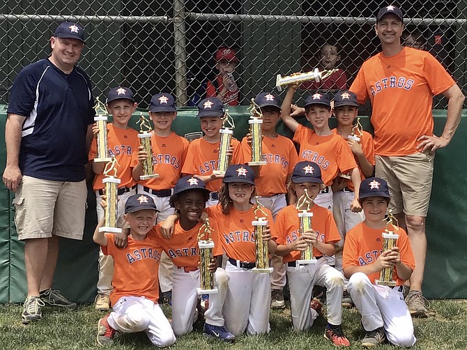 The Great Falls Astros celebrate a championship victory in Spring 2019. Back row (from left): Dan Ryan, Trey Donovan, Clay Rossen, Morgan Rossen, Lachen Singh, Ian Byrd, Dominic Gaudiano, Mike Byrd. Front row (from left: Connor Sarin, Tyson Armah, Emma Ryan, Owen Conrad, Jude Miller.