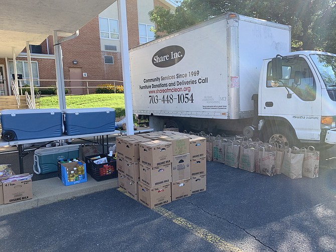 Grab-and-go food containers await distribution on Wednesday morning. Share volunteers now carry boxes to clients’ cars to maintain social distance on the twice-weekly distribution days.