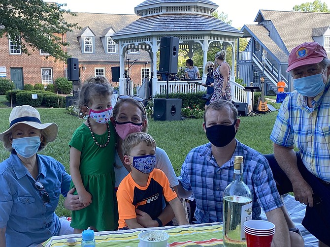 Deb Bouchoux of Great Falls (left) and her husband, Don Bouchoux (far right) with granddaughter Kate Burnette, 3, daughter Liz Burnette, grandson  Benjamin Burnette, 5, and son-in-law Dan Burnette at the season’s opening night for Concerts on the Green in Great Falls.