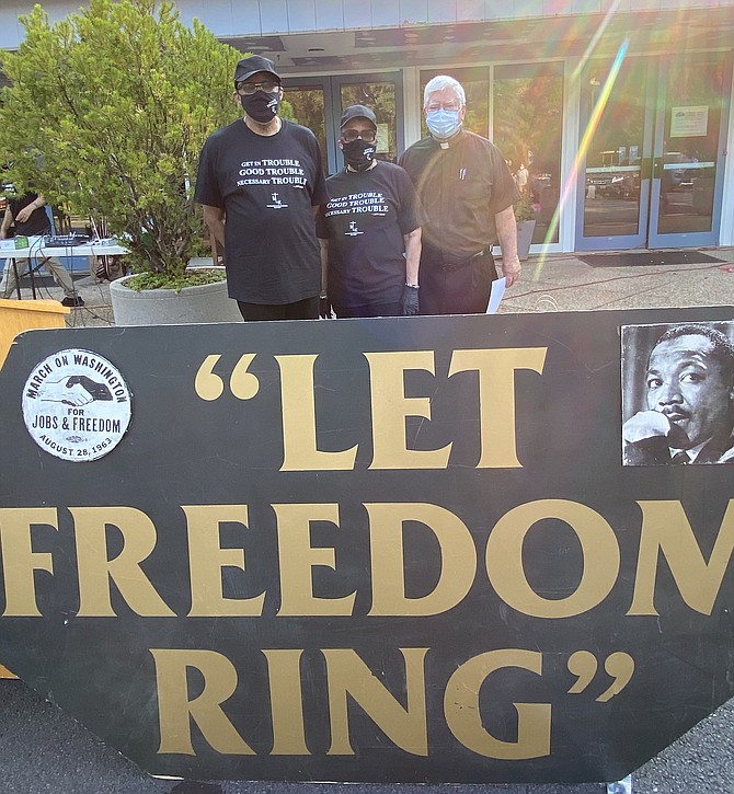 Reverend Clyde Casey, Associate Pastor of Martin Luther King Jr. Christian Church Reston; Reverend Dr. Jean Robinson-Casey, Pastor Martin Luther King Jr. Christian Church Reston; and Reverend William B. Schardt, Pastor St. Thomas à Becket Catholic Church, gather before giving the Invocation, Welcome and Prayer respectively during the Faith and Justice Car Rally in Reston.