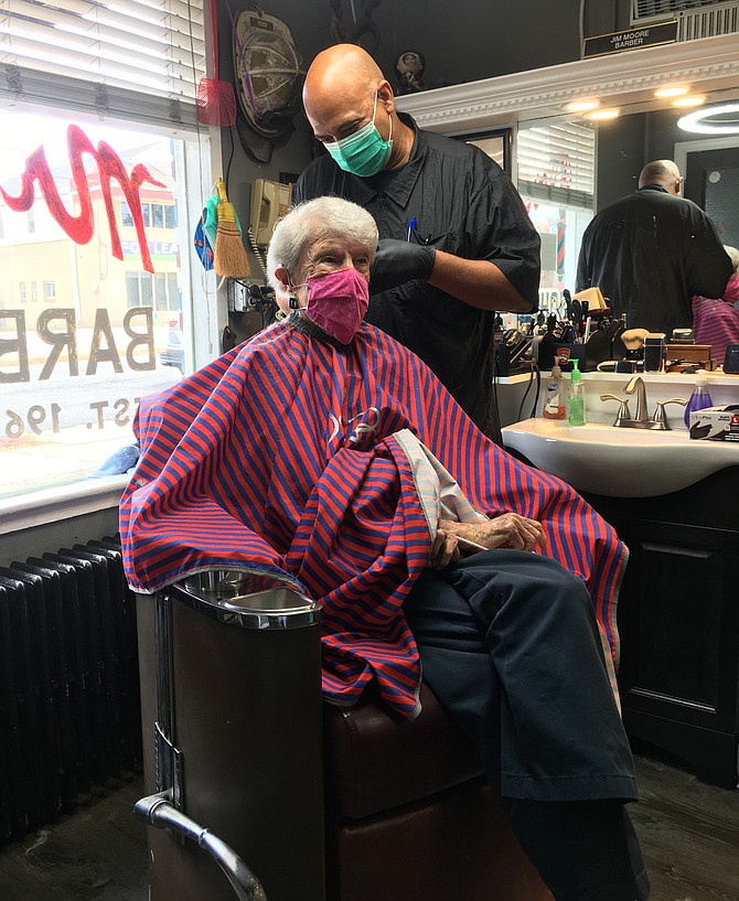 Ann Shanley, 91, hadn’t had her hair cut since late February, when her assisted living facility ceased salon services. She was too afraid to go out for a cut; she didn’t want to put others in her residence at risk.  But she finally reached the point where she had to have a hair cut. In June, she learned Jim Moore’s barber shop on Lee Highway was cutting hair by appointment:  Moore’s safety measures and the neighborhood reputation of his shop convinced her to go.