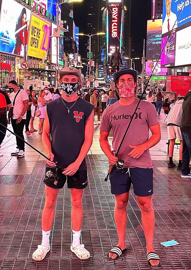 (From left) Daniel Balserak and Luke Konson in Times Square with their rods. They stopped on their way to Rhode Island.