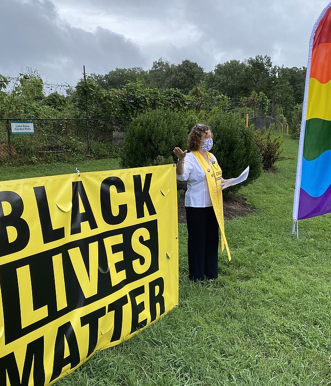 Rev. Dr. Debra W. Haffner dedicates the newly installed  Rainbow flag and the  Black Lives Matter banner at Unitarian Universalist Church in Reston on Sept. 12, 2020.