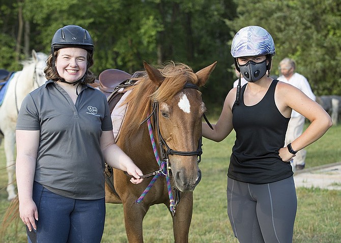 “Best part is getting to hang out with awesome people, like Nicole.” Nicole Springer of Sterling and Meagan Hosker of Reston with Huckleberry.